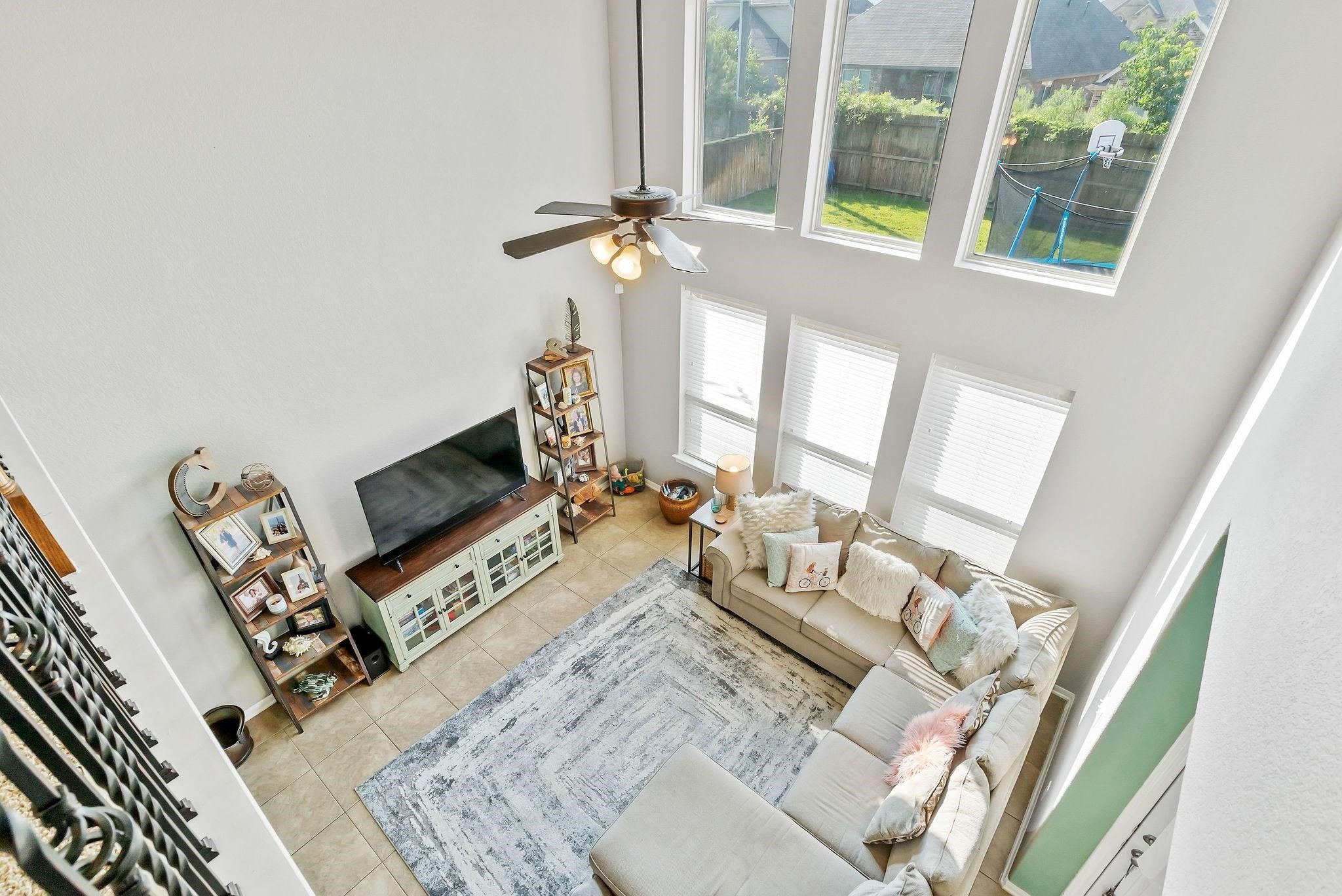 62 West Lasting Spring Circle The Woodlands, TX 77389 - Photo 33 of 46 a living room with furniture a fireplace and a floor to ceiling window