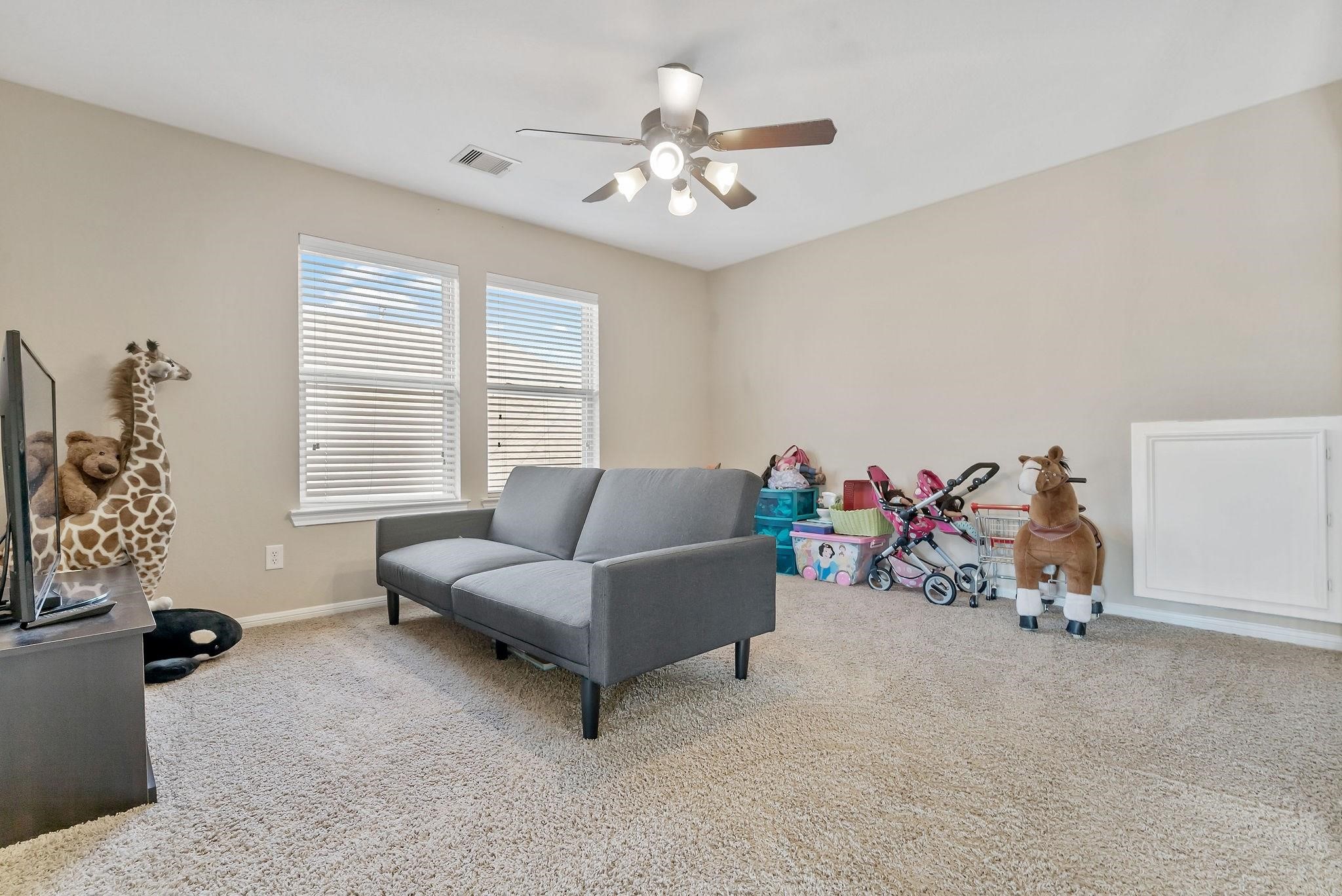 62 West Lasting Spring Circle The Woodlands, TX 77389 - Photo 38 of 46 a living room with furniture and a chandelier