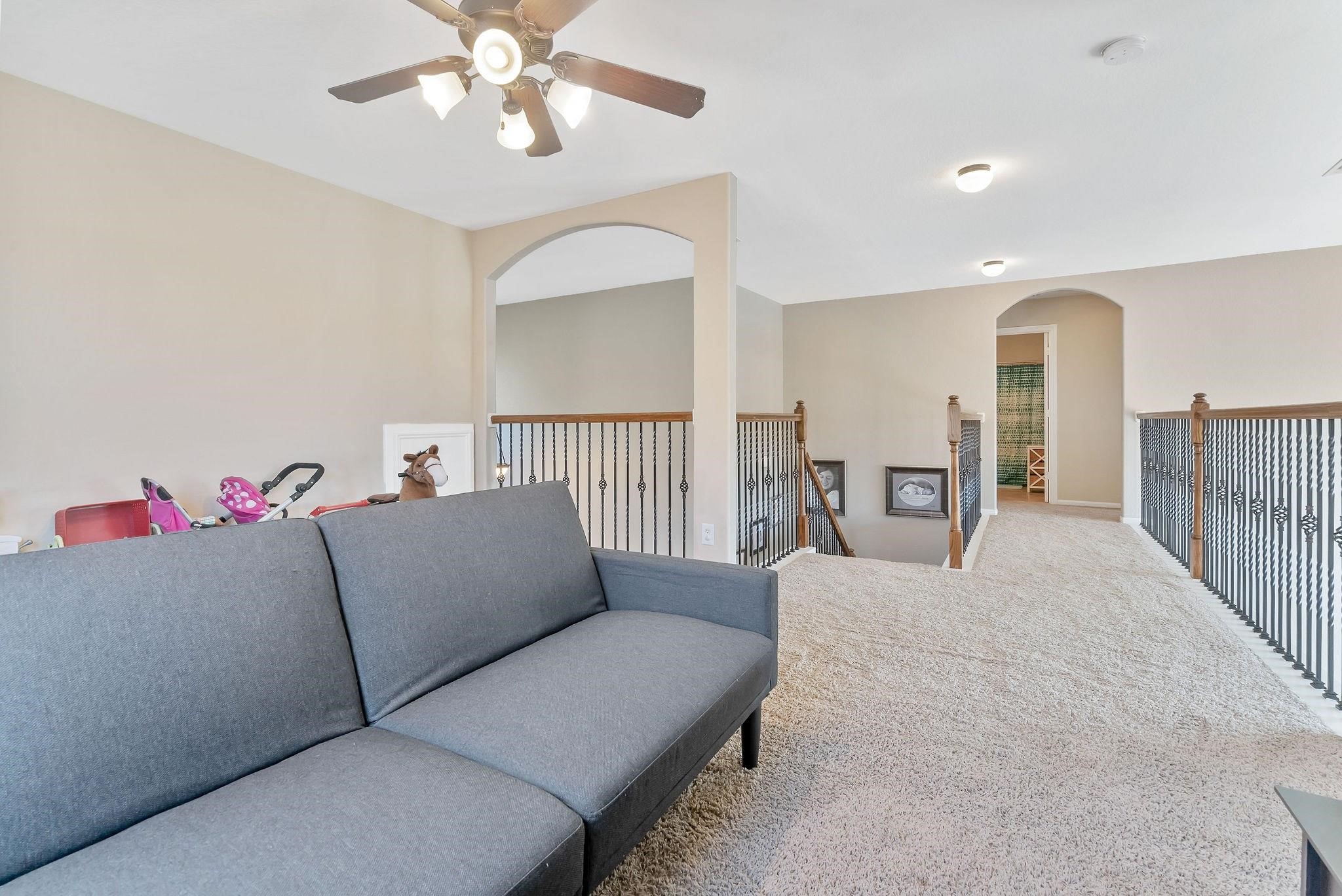 62 West Lasting Spring Circle The Woodlands, TX 77389 - Photo 40 of 46 a living room with furniture and a chandelier