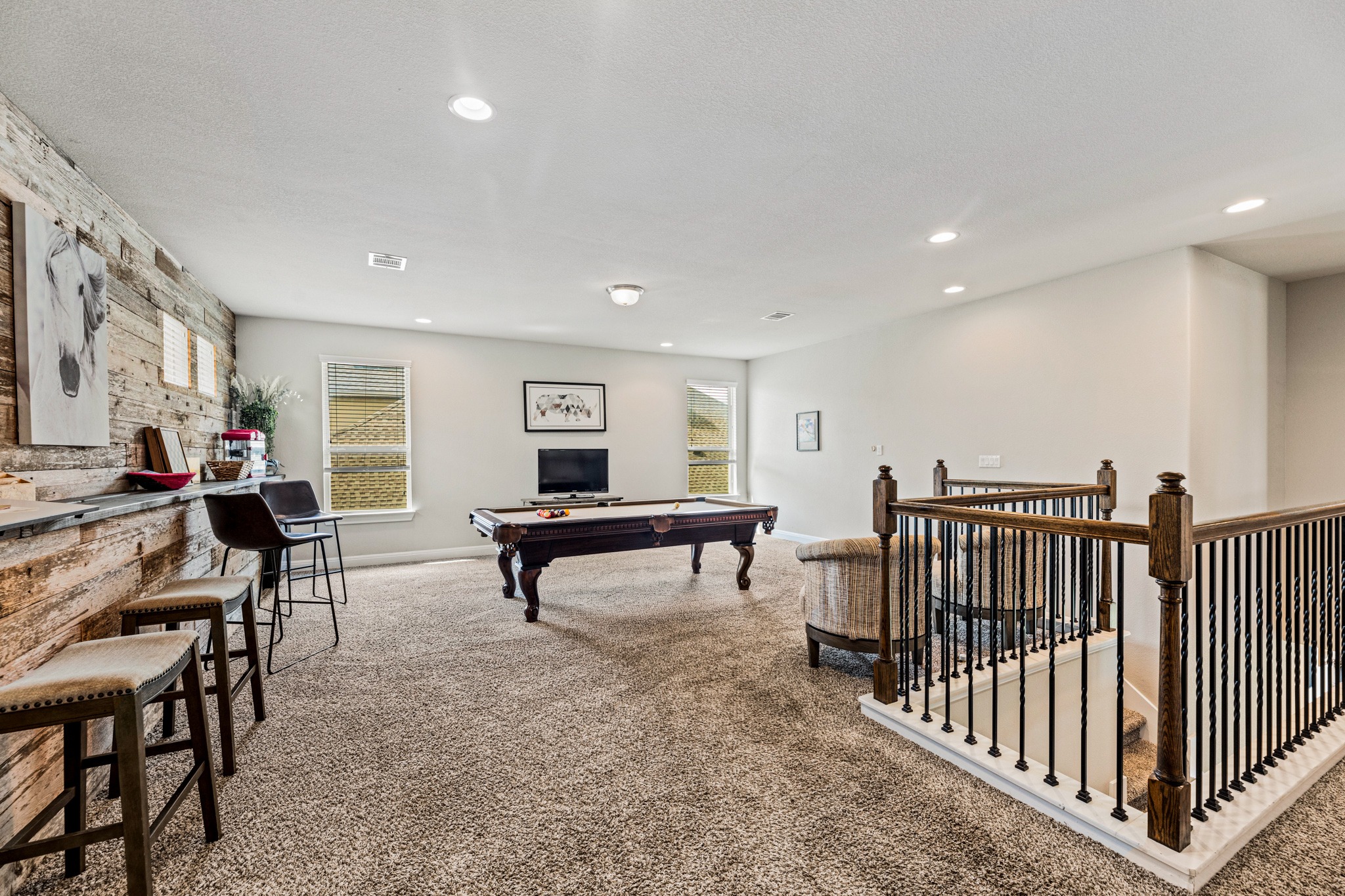 108 Redtail Lane Leander, TX 78641 - Photo 19 of 39 A versatile bonus room featuring a built-in bar, recessed lighting, and ample space for recreation.