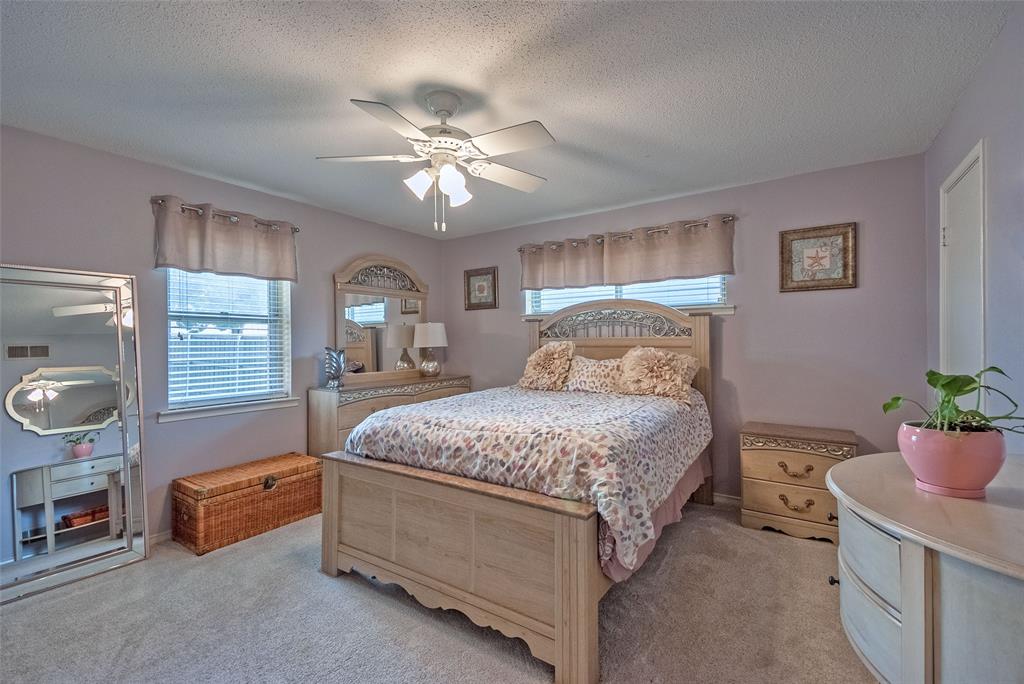 5739 Banting Way Dallas, TX 75227 - Photo 12 of 15 a bedroom with a bed and a chandelier