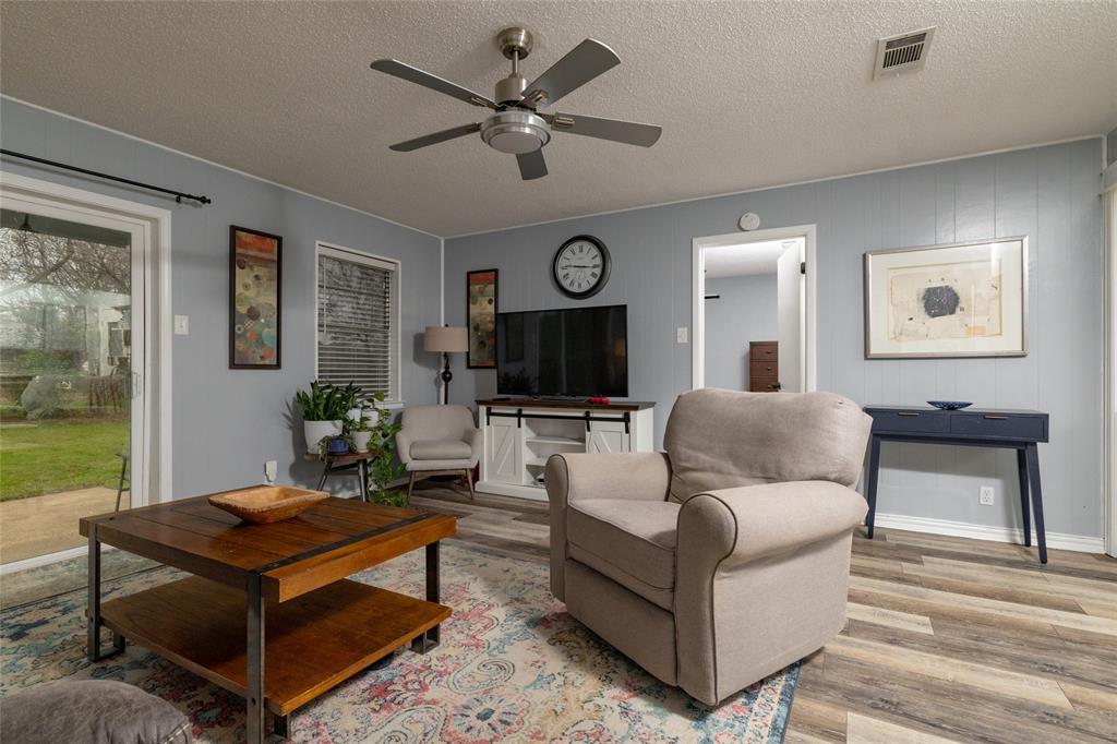 6020 Harrison Way Watauga, TX 76148 - Photo 13 of 32 Living area with a textured ceiling, wood finished floors, and ceiling fan