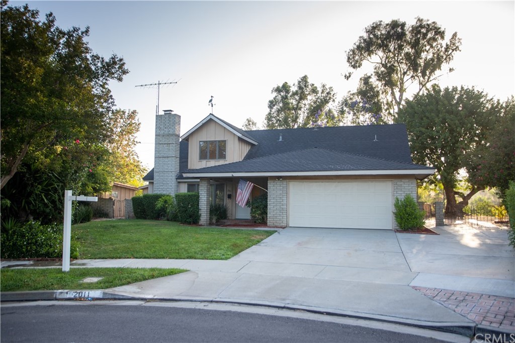 a front view of house with yard and trees
