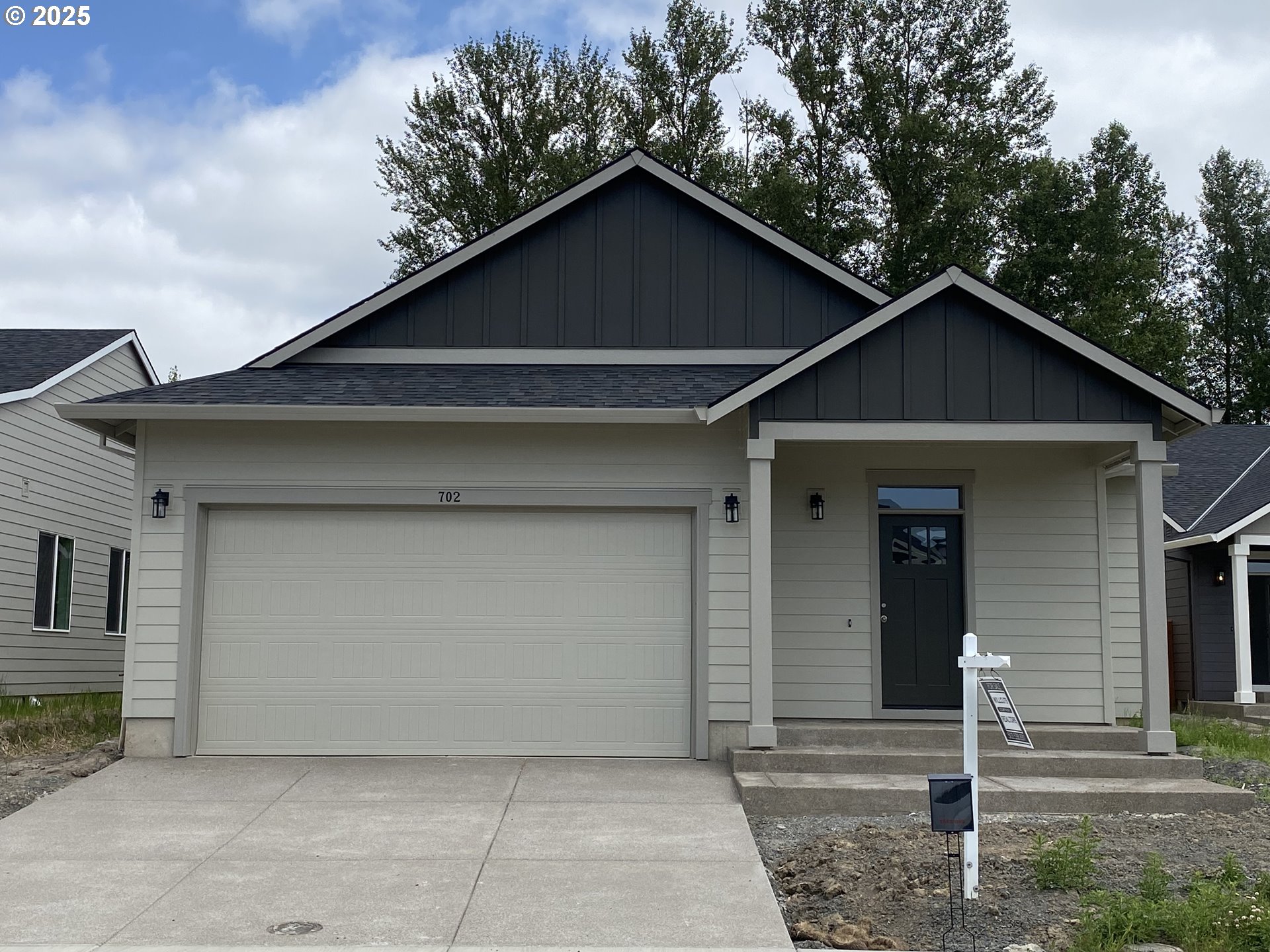 702 Tigerlily Street Silverton, OR 97381 - Photo 1 of 31 a front view of a house with garage