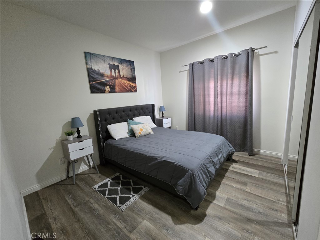 8026 Telegraph Road Downey, CA 90240 - Photo 12 of 26 a bedroom with a bed and wooden floor