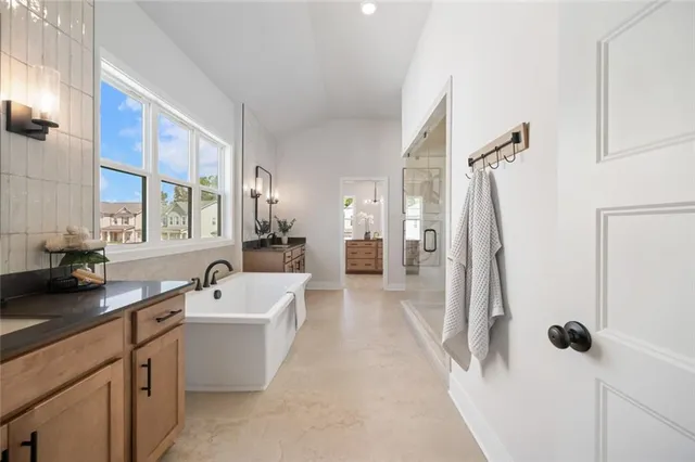 a bedroom with a large bed and a potted plant