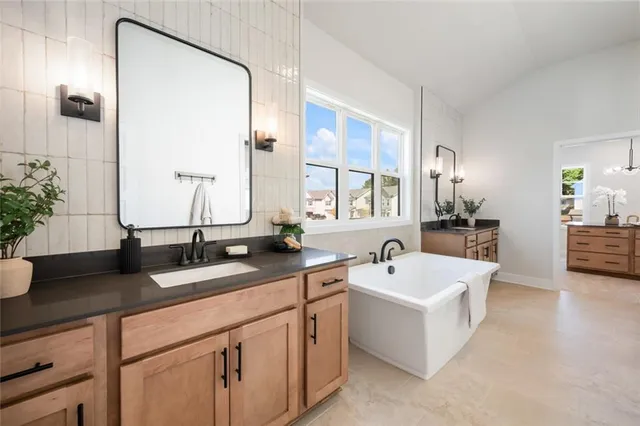 a spacious bedroom with a bed and painting on the wall