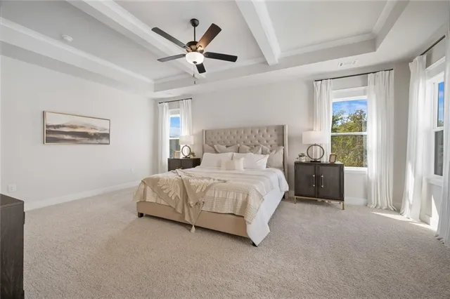a dining room with wooden floor a chandelier a wooden table and chairs