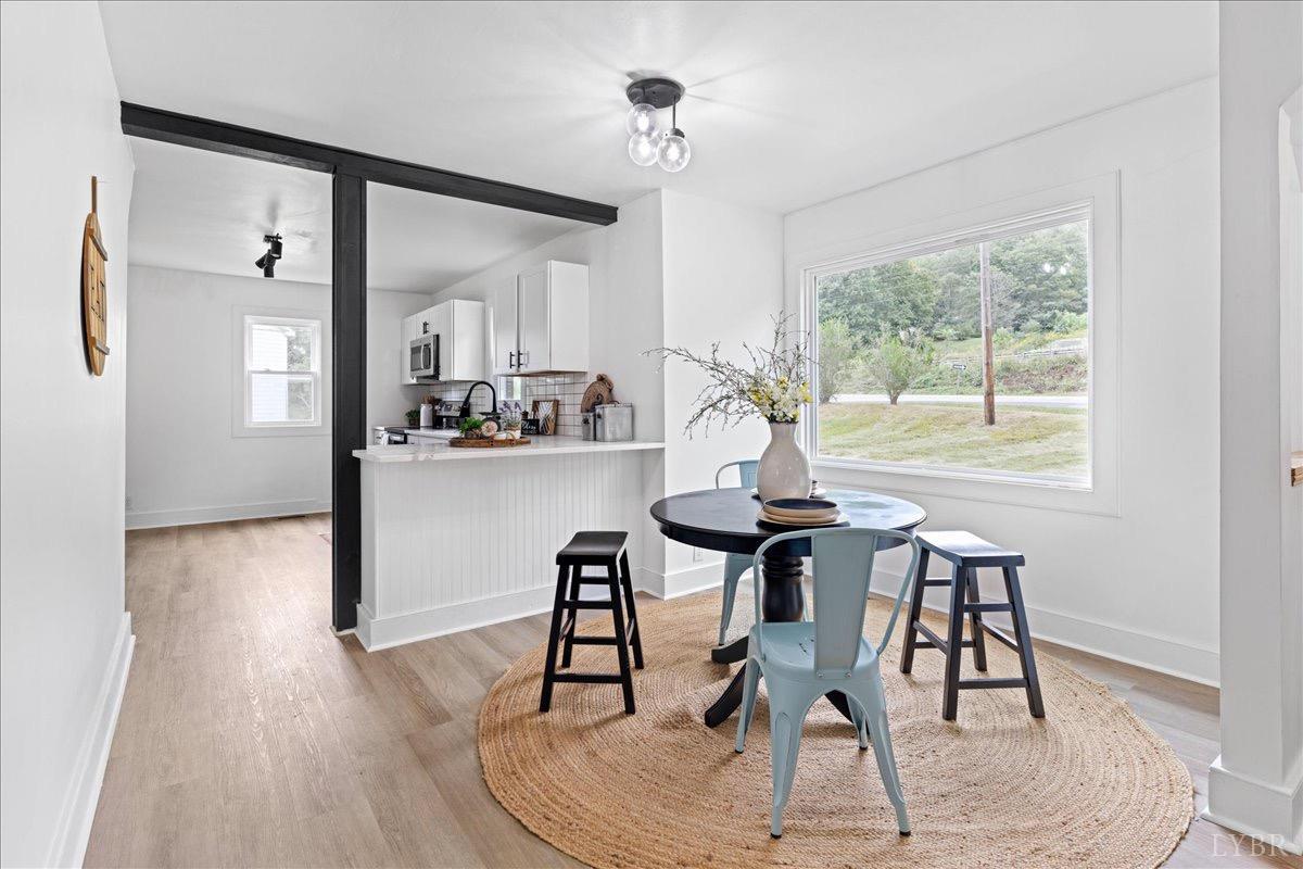 15 Cannery Loop Lovingston, VA 22949 - Photo 11 of 60 a dining room with wooden floor and a chandelier