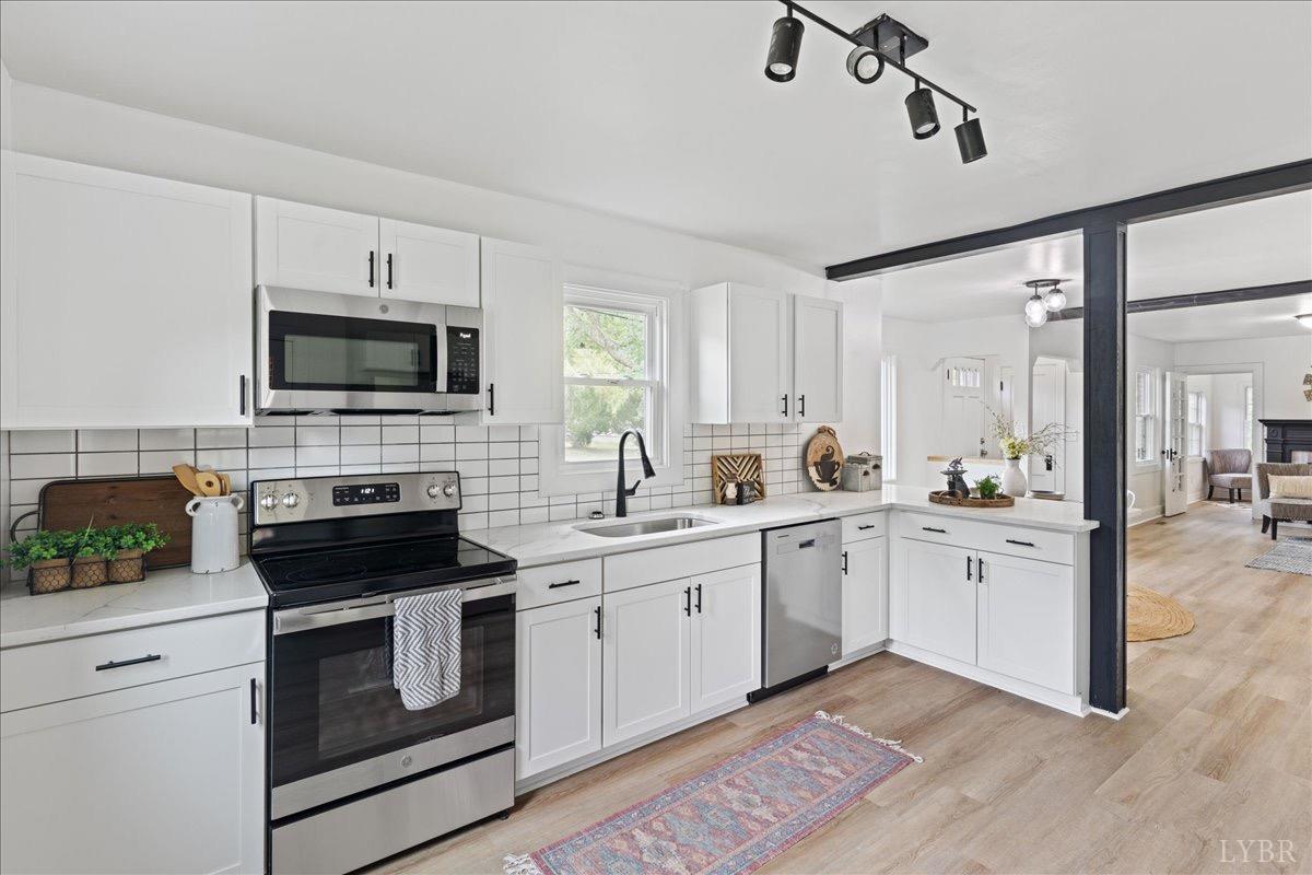 15 Cannery Loop Lovingston, VA 22949 - Photo 13 of 60 a kitchen with white cabinets and appliances