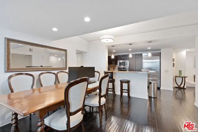 a dining room with furniture a chandelier and wooden floor
