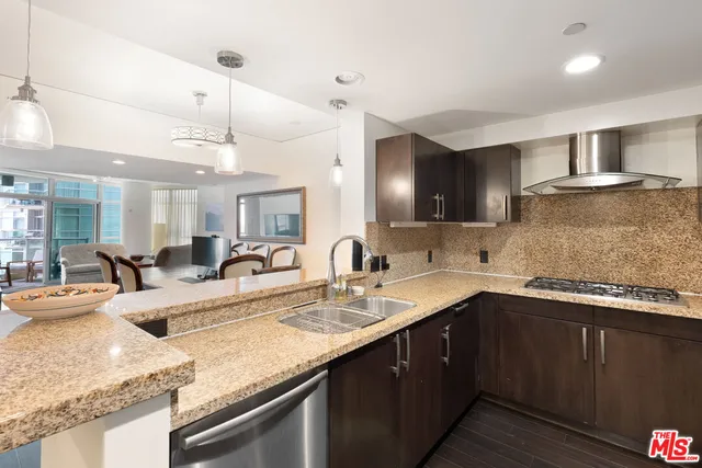 a kitchen with a sink a stove and cabinets