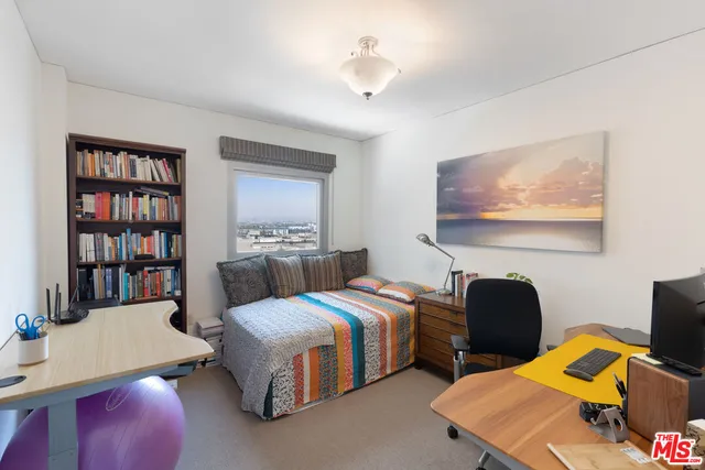 a bedroom with furniture and a book shelf