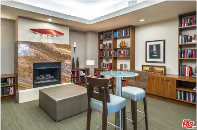 a living room with furniture and a bookshelf
