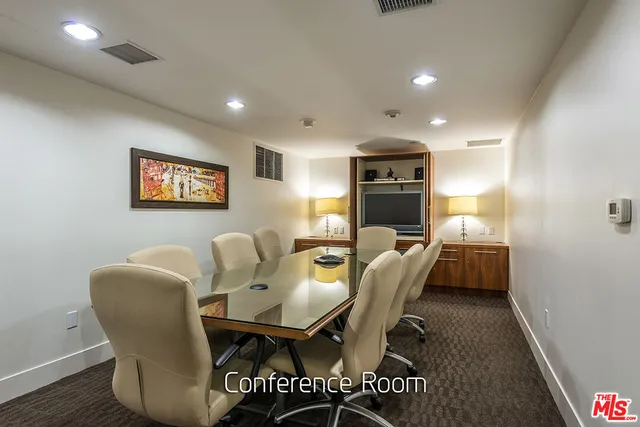 a dining room with furniture and a floor to ceiling window