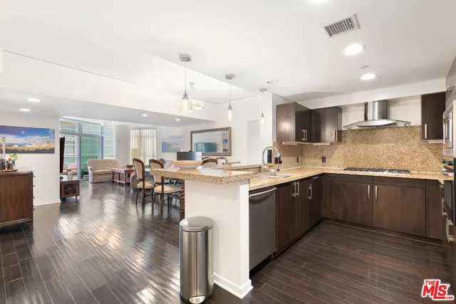 a kitchen with lots of counter top space and painting on the wall