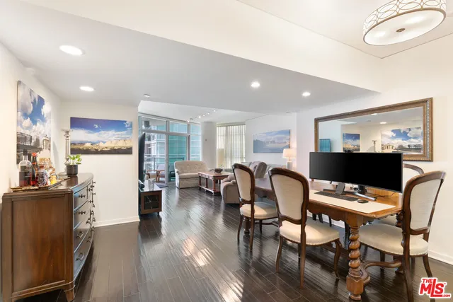 a dining room with furniture and kitchen view