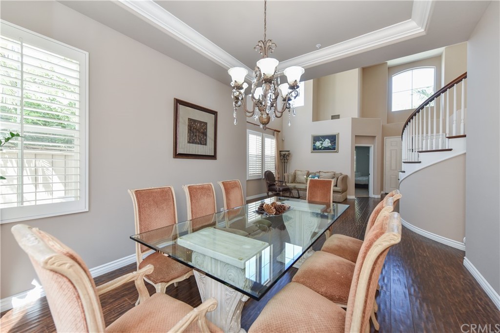 23 Benavente Irvine, CA 92606 - Photo 11 of 44 a living room with furniture a chandelier and a window