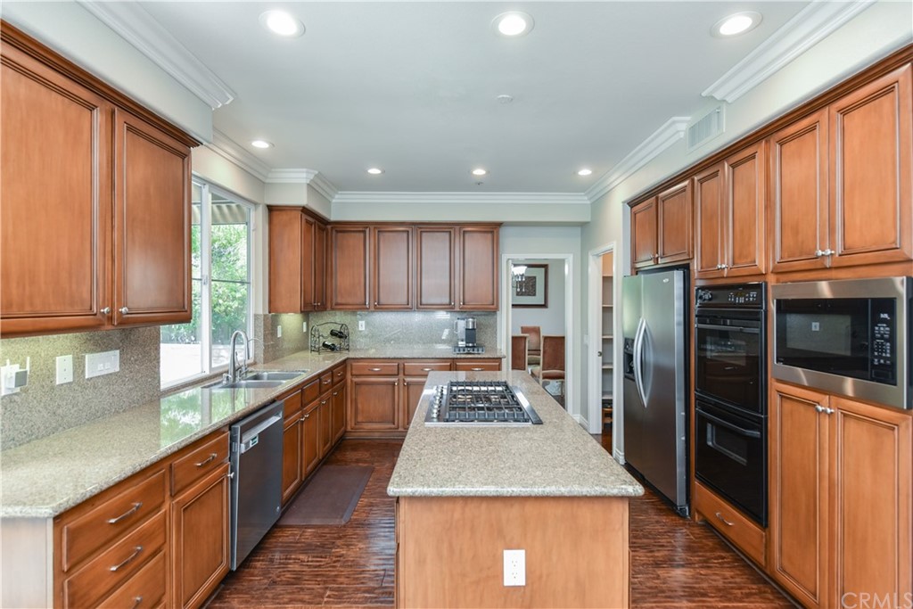 23 Benavente Irvine, CA 92606 - Photo 14 of 44 a kitchen with stainless steel appliances granite countertop sink stove refrigerator and cabinets