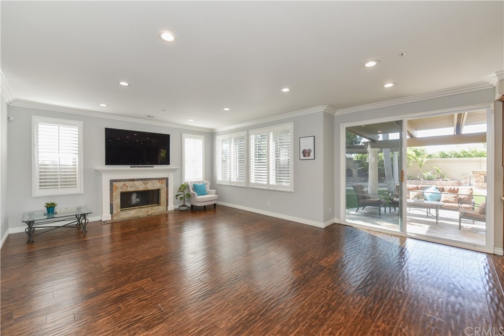 23 Benavente Irvine, CA 92606 - Photo 15 of 44 an empty room with wooden floor and fireplace