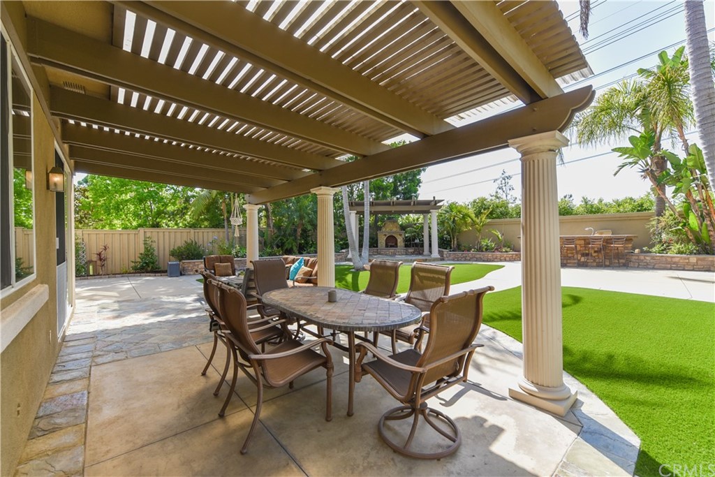 23 Benavente Irvine, CA 92606 - Photo 25 of 44 a view of a patio with a table chairs and a backyard