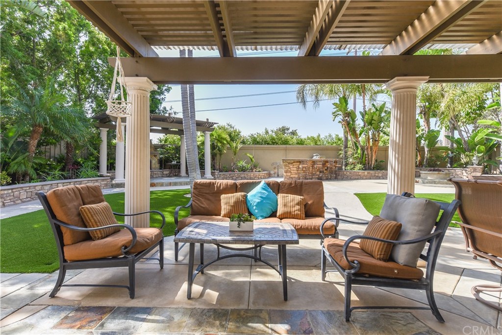23 Benavente Irvine, CA 92606 - Photo 27 of 44 a view of a patio with a table chairs and a backyard