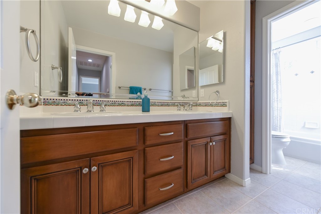 23 Benavente Irvine, CA 92606 - Photo 31 of 44 a bathroom with a sink vanity and a mirror