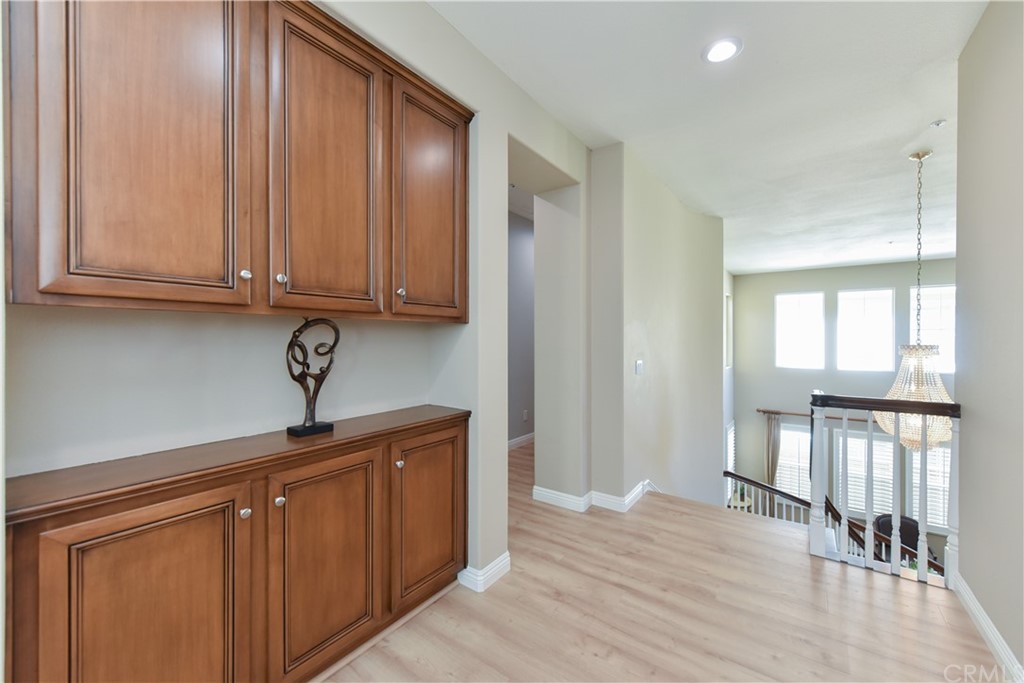 23 Benavente Irvine, CA 92606 - Photo 35 of 44 a kitchen with a sink cabinets and wooden floor