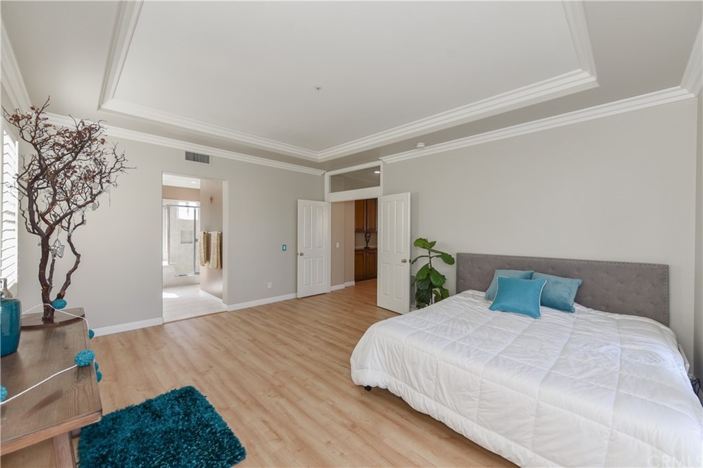 23 Benavente Irvine, CA 92606 - Photo 36 of 44 a bedroom with a large bed and a potted plant