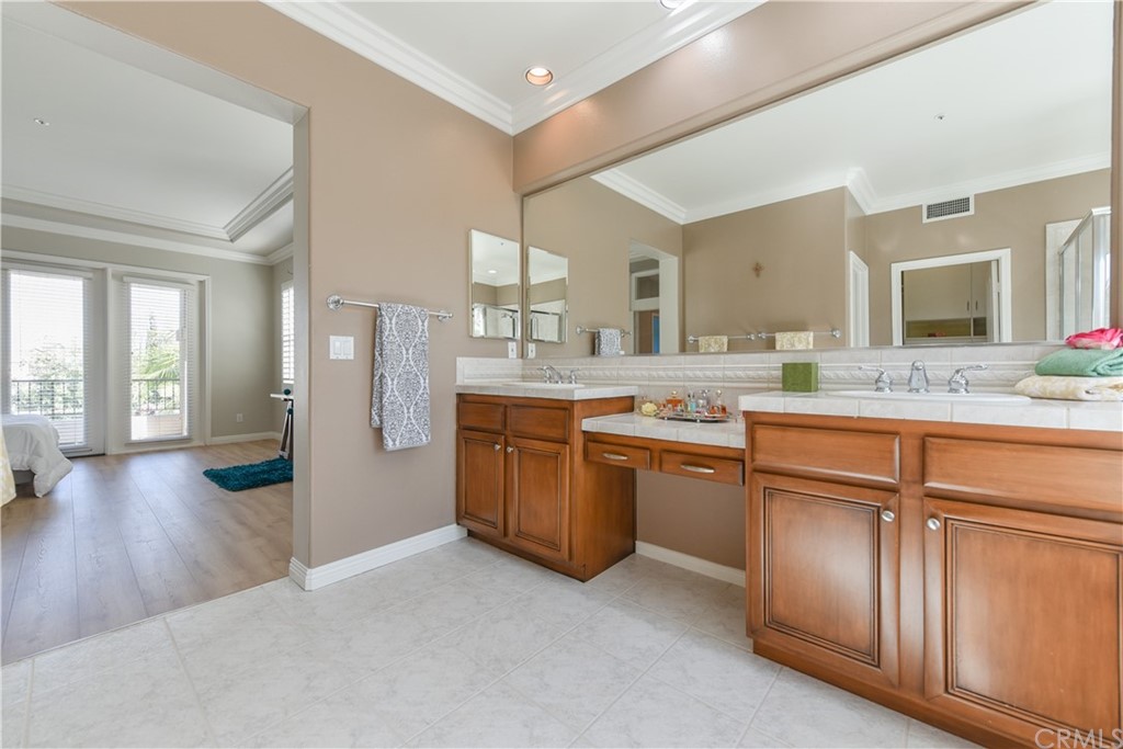 23 Benavente Irvine, CA 92606 - Photo 39 of 44 a bathroom with a granite countertop sink mirror and view
