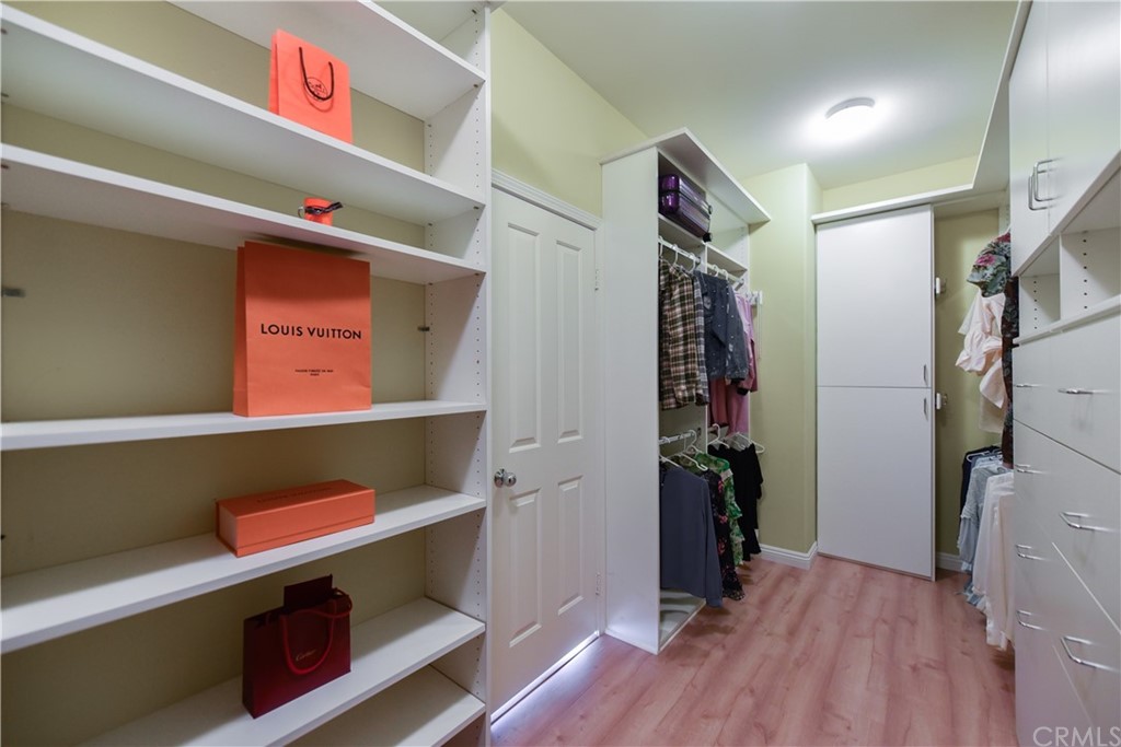 23 Benavente Irvine, CA 92606 - Photo 41 of 44 a view of walk in closet with clothes and shoes