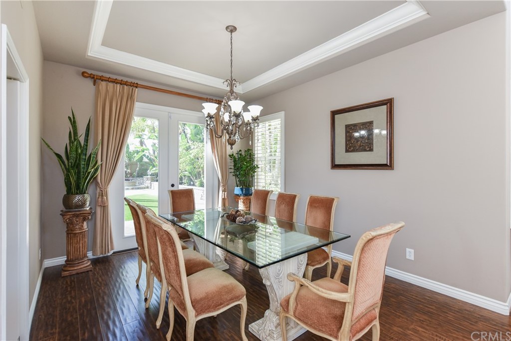 23 Benavente Irvine, CA 92606 - Photo 10 of 44 a dining room with furniture potted plants and wooden floor
