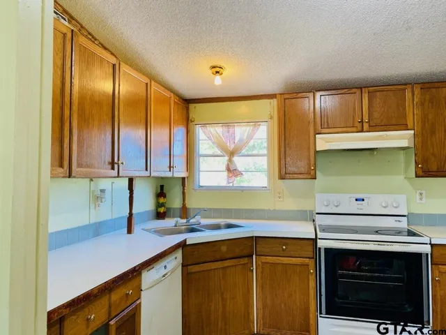 a kitchen with a sink cabinets and window