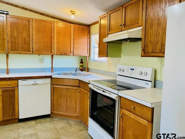 a kitchen with a sink cabinets and window