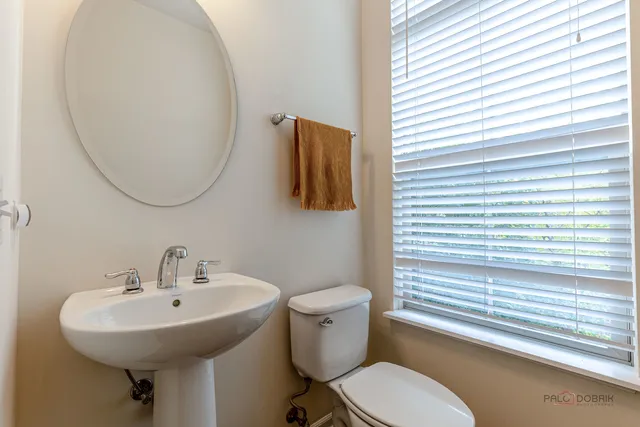 a bathroom with a sink a mirror and a toilet