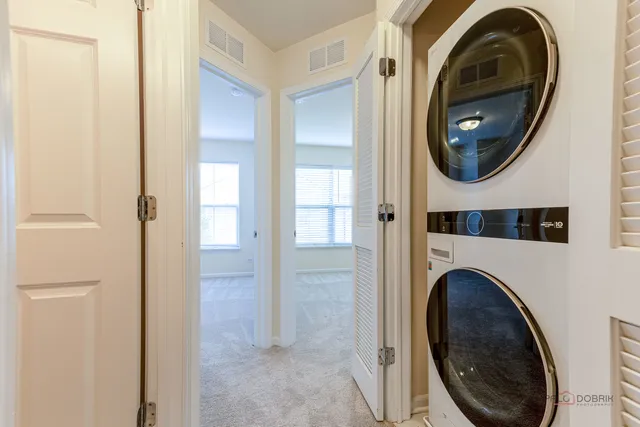 a view of a hallway with washer and dryer