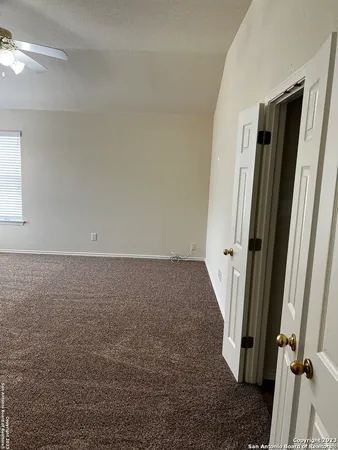 en empty room with windows and fan