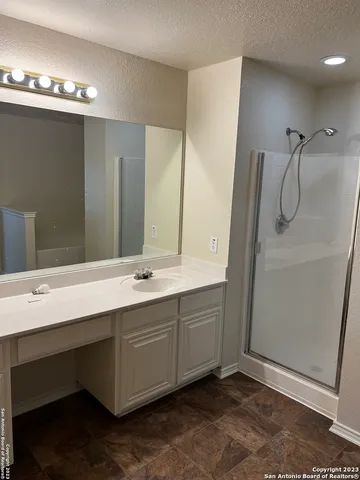 a bathroom with a sink mirror and a bathtub