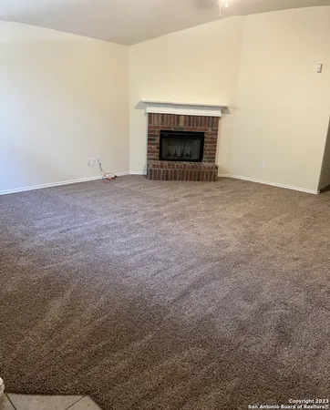 an empty room with a fireplace