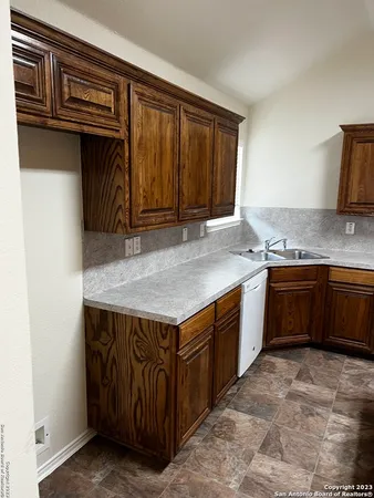 a kitchen with a stove a sink and a refrigerator