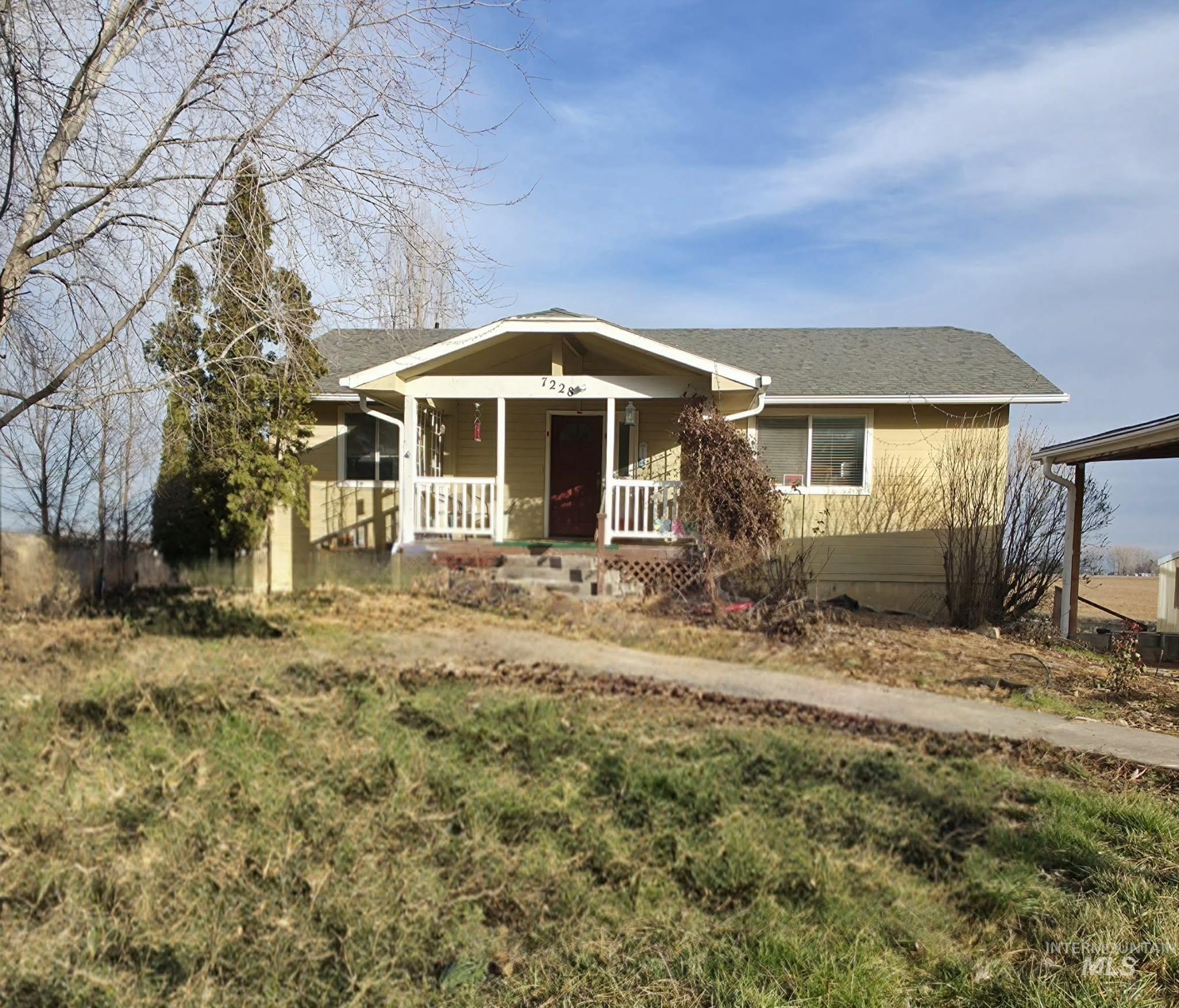 View of front of home featuring covered porch and roof with shingles