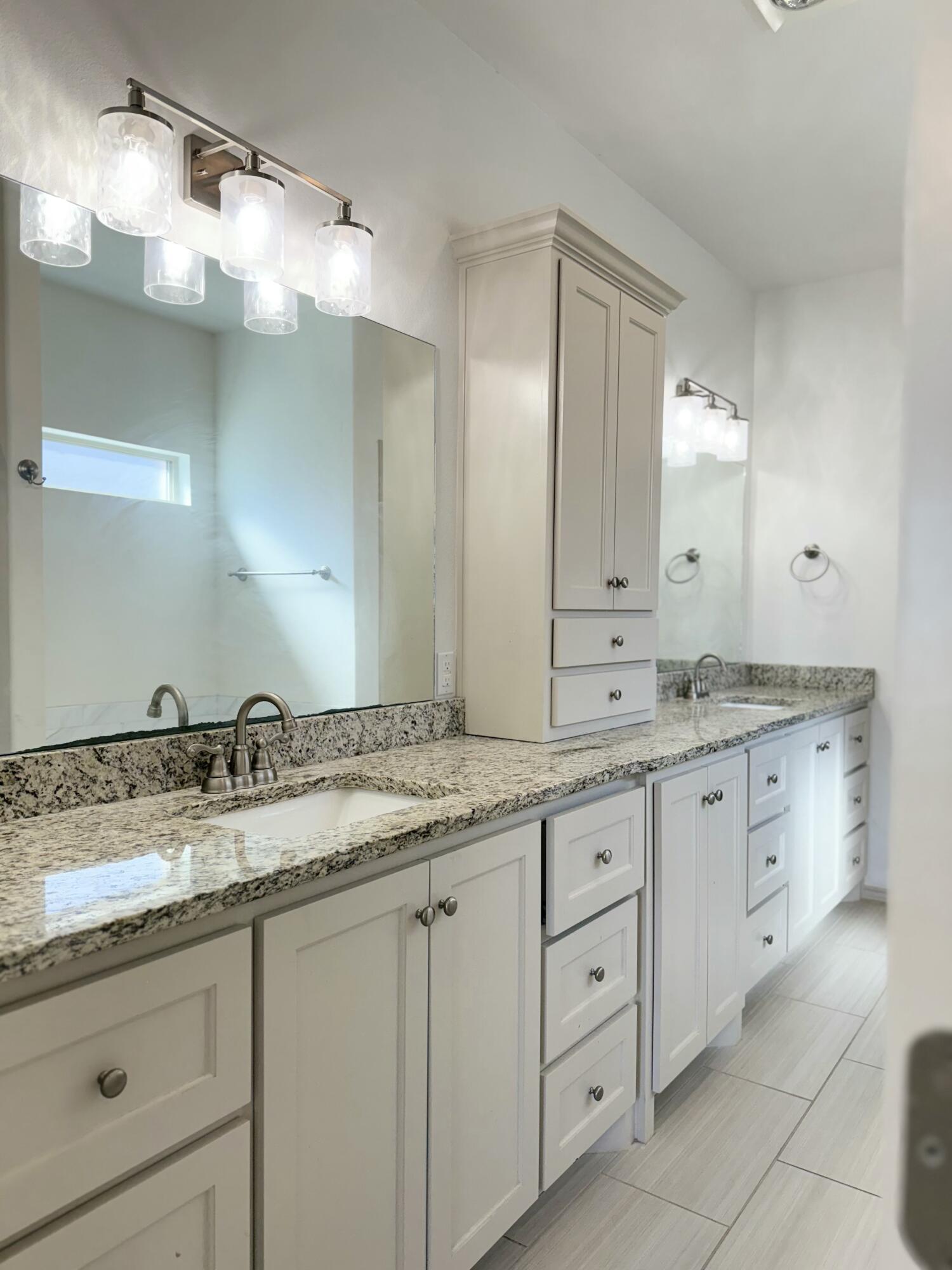 12202 Ithaca Avenue Lubbock, TX 79423 - Photo 13 of 28 a bathroom with a granite countertop sink double and mirror