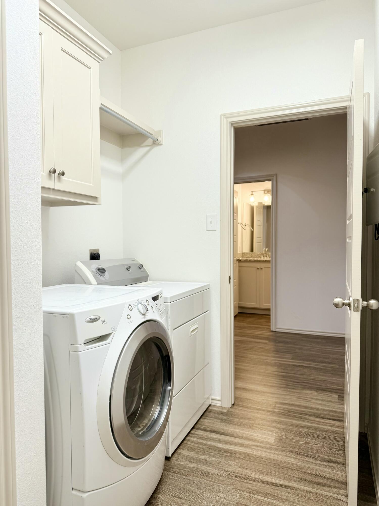 12202 Ithaca Avenue Lubbock, TX 79423 - Photo 16 of 28 a view of storage and utility room with washer and dryer