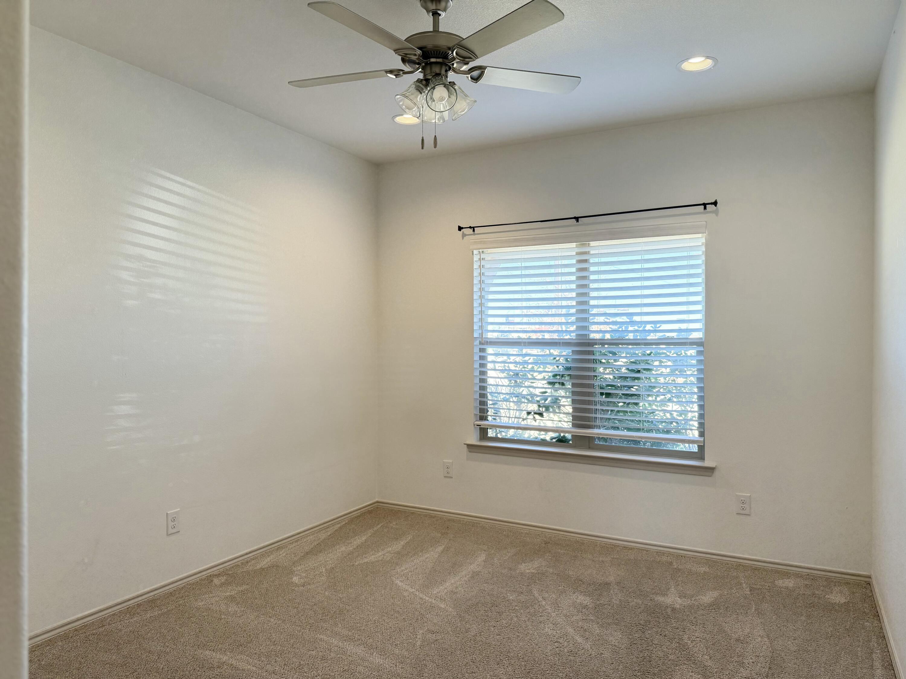 12202 Ithaca Avenue Lubbock, TX 79423 - Photo 18 of 28 an empty room with windows and fan