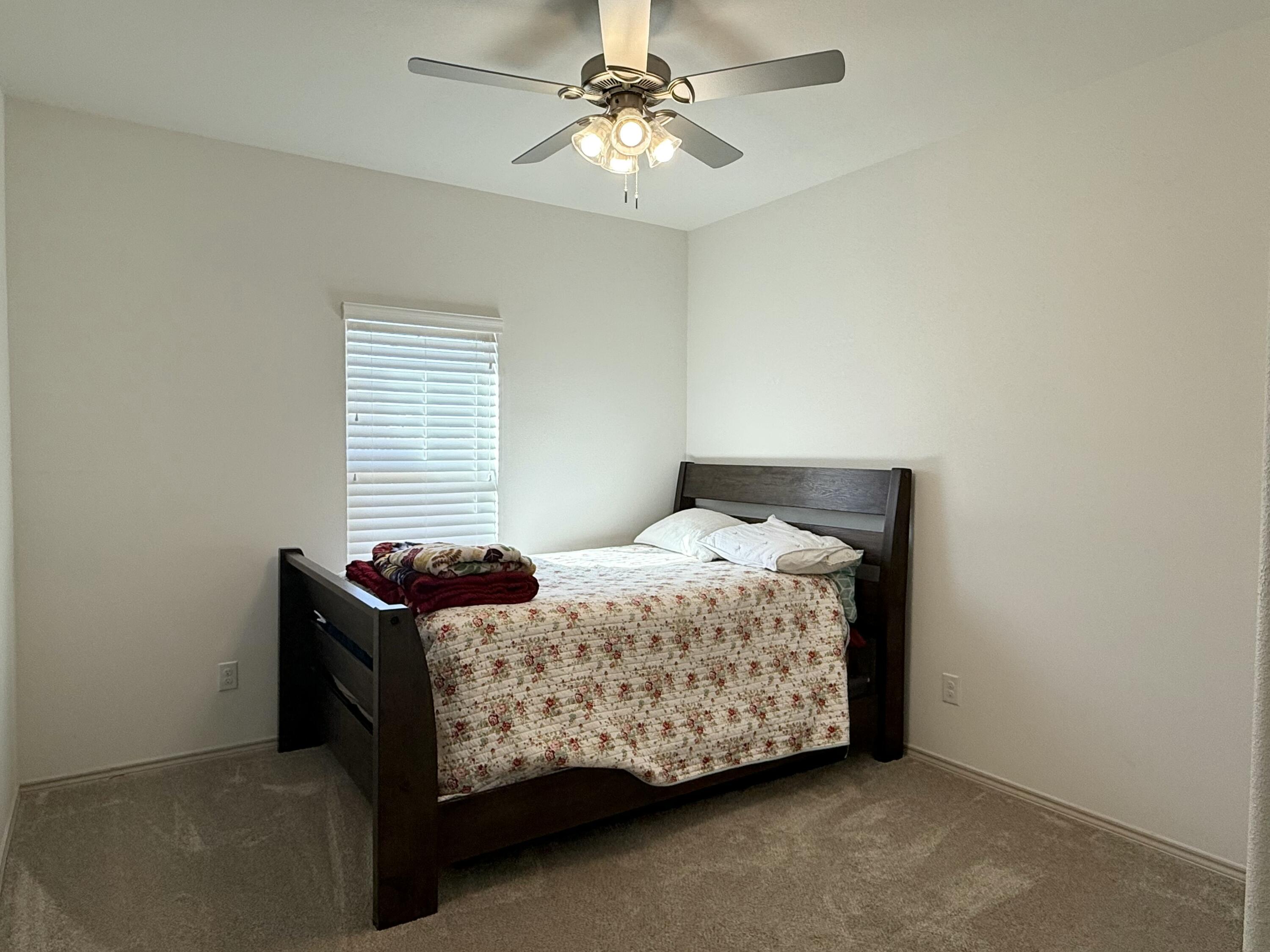 12202 Ithaca Avenue Lubbock, TX 79423 - Photo 21 of 28 a bedroom with a bed and window