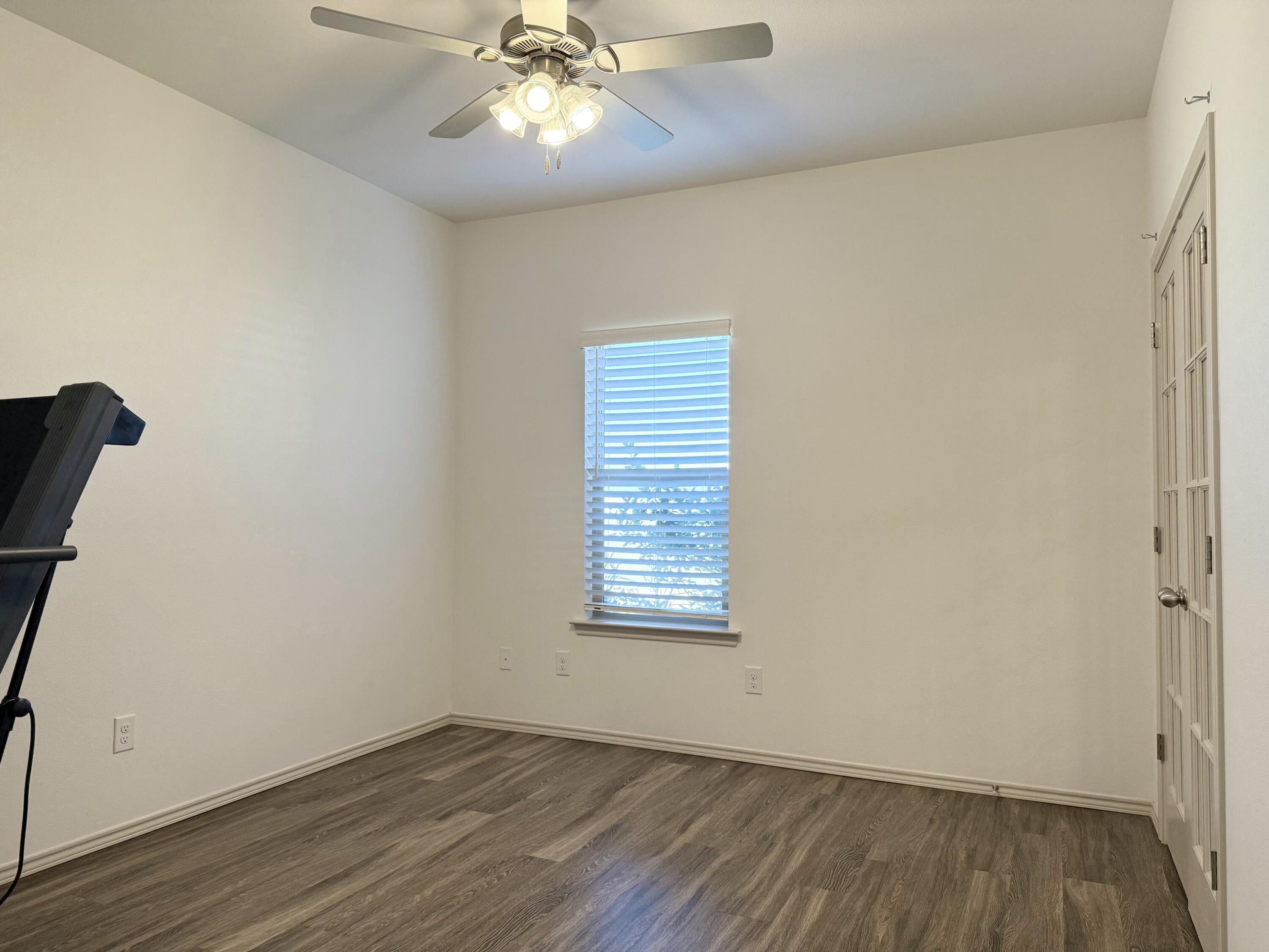 12202 Ithaca Avenue Lubbock, TX 79423 - Photo 23 of 28 an empty room with wooden floor closet and windows
