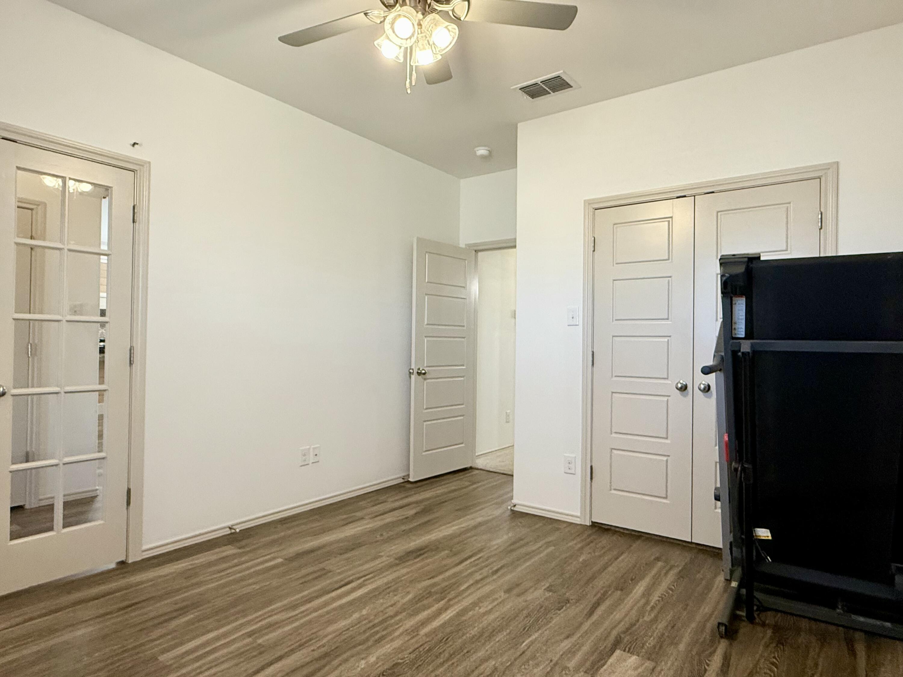 12202 Ithaca Avenue Lubbock, TX 79423 - Photo 24 of 28 an empty room with wooden floor cabinet and a refrigerator