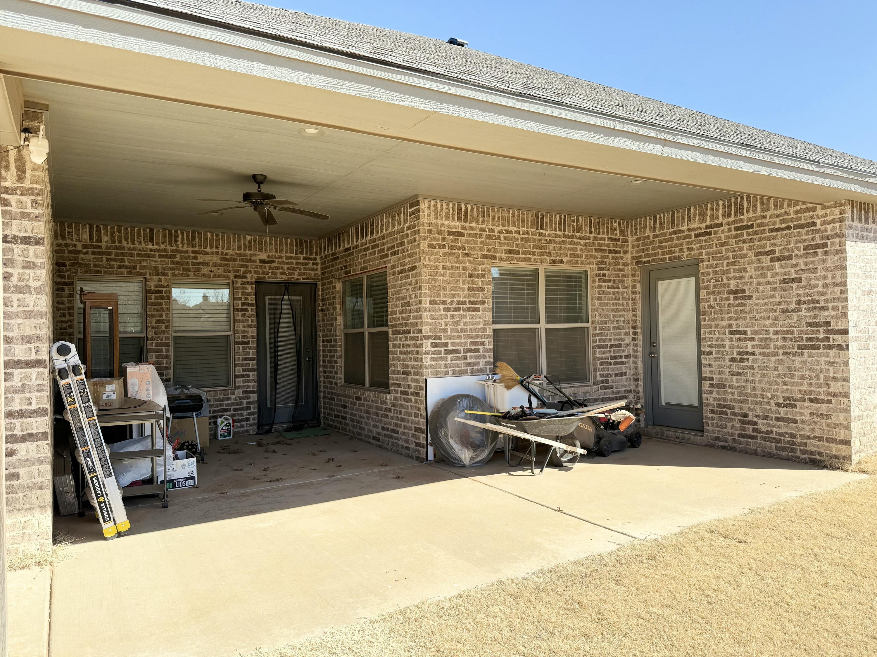 12202 Ithaca Avenue Lubbock, TX 79423 - Photo 26 of 28 a view of a patio with table and chairs and floor to ceiling window
