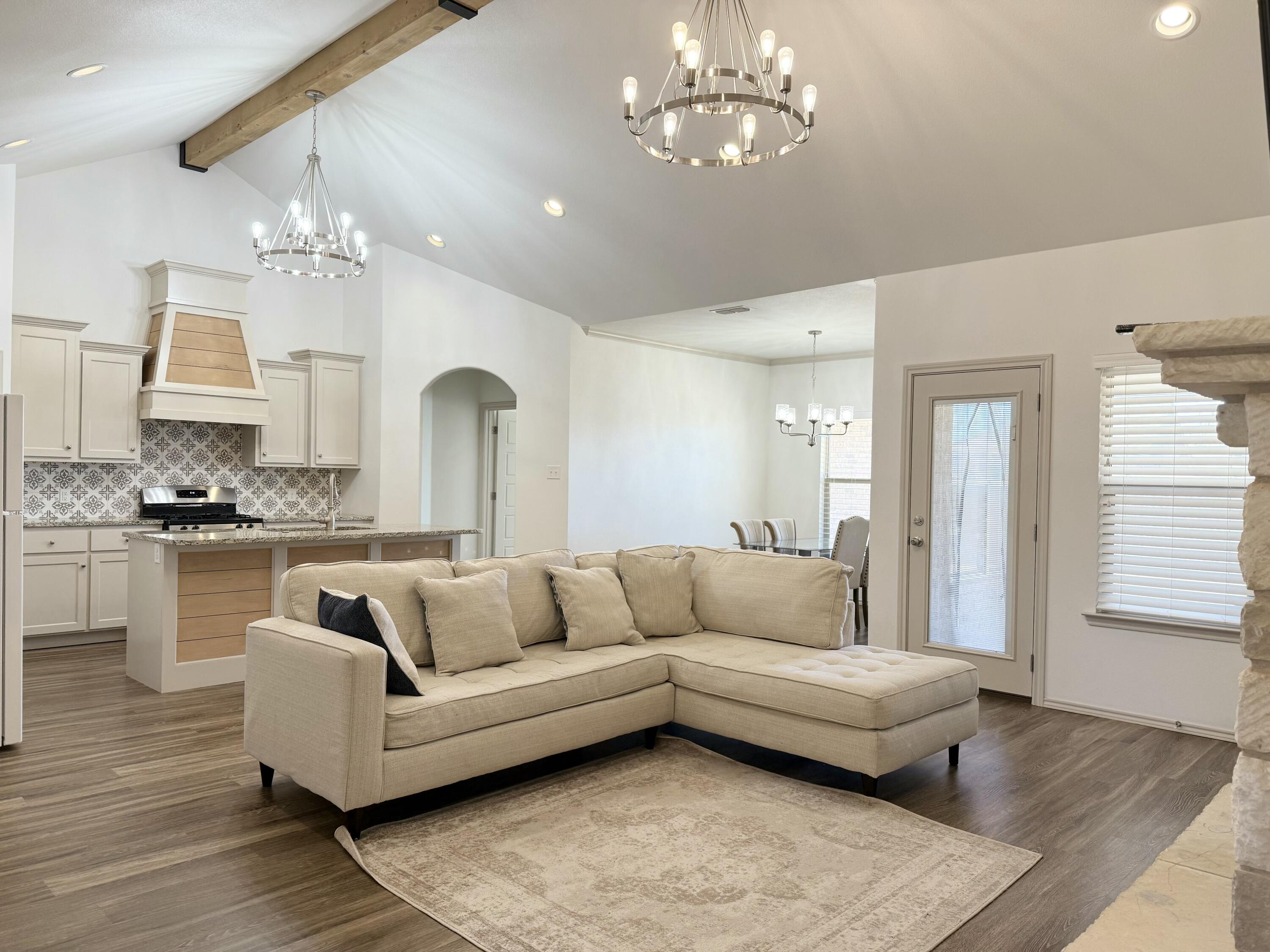 12202 Ithaca Avenue Lubbock, TX 79423 - Photo 4 of 28 a living room with furniture and kitchen view