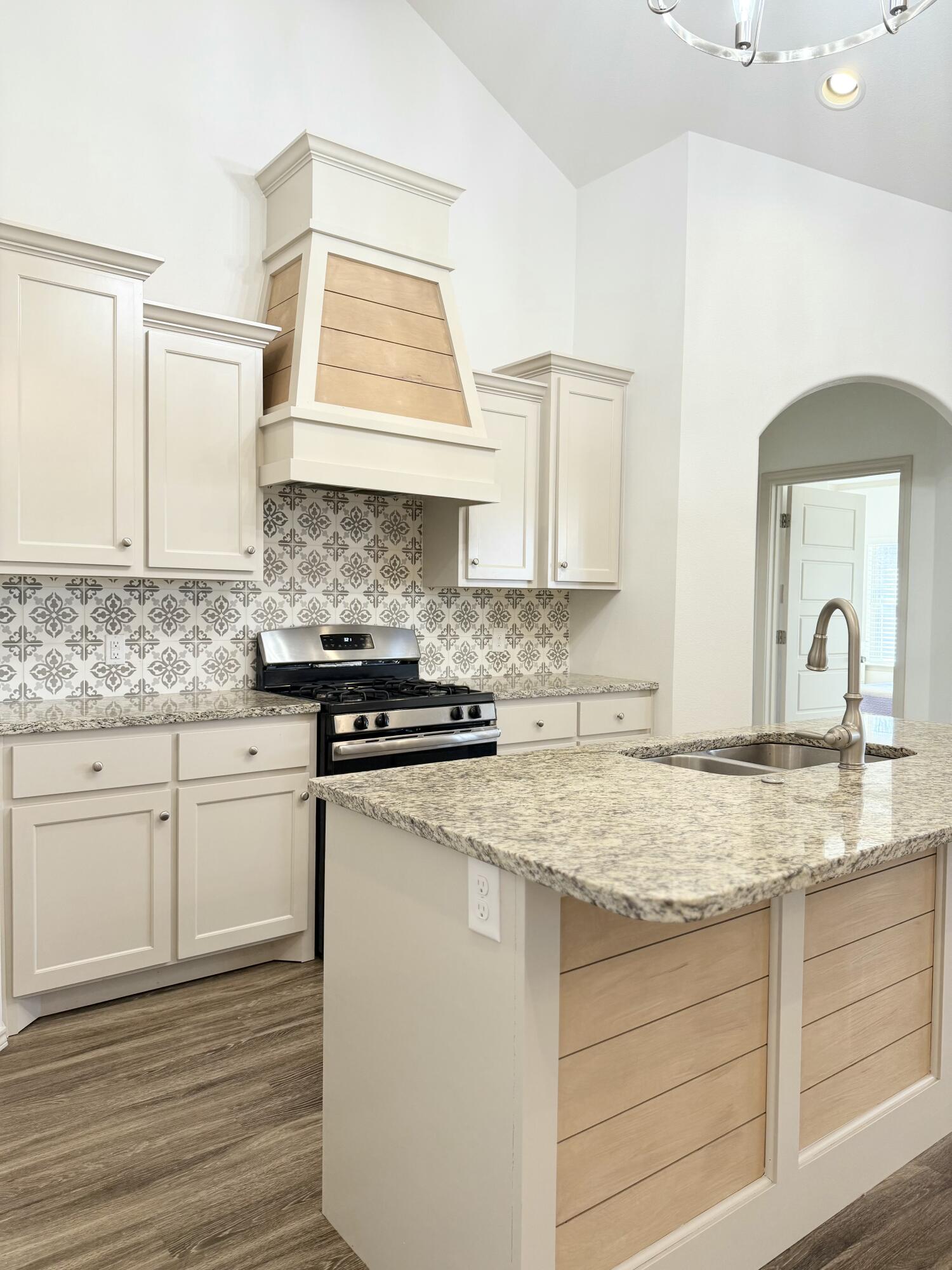 12202 Ithaca Avenue Lubbock, TX 79423 - Photo 7 of 28 a kitchen with granite countertop white cabinets and a sink